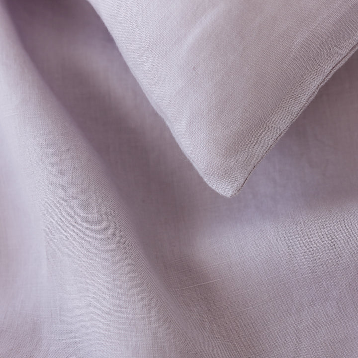Foxtrot Home French Flax Linen styled in a bedroom with Lilac Pillowcases.