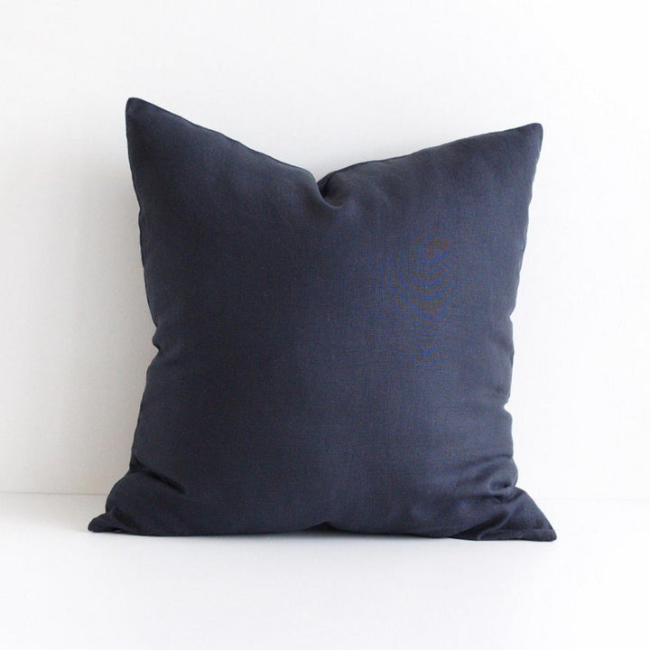 Foxtrot Home French Flax Linen styled in a bedroom with Midnight Blue Cushion Cover.