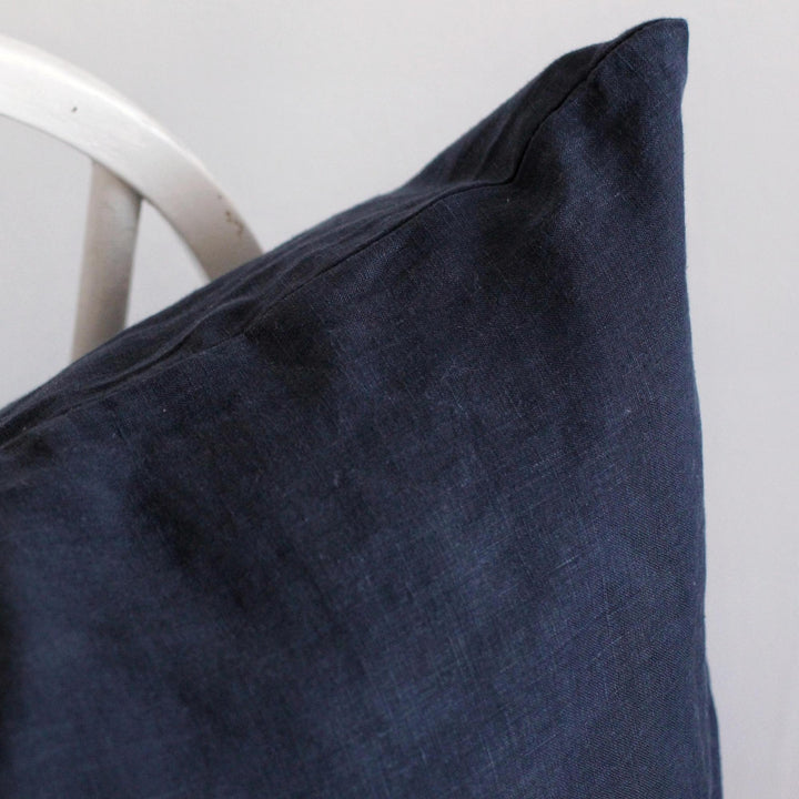 Foxtrot Home French Flax Linen styled in a bedroom with Midnight Blue Cushion Cover.