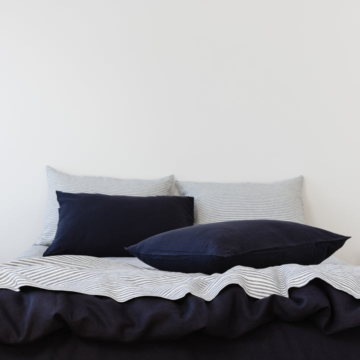 Foxtrot Home French Flax Linen styled in a bedroom with Midnight Blue Duvet.