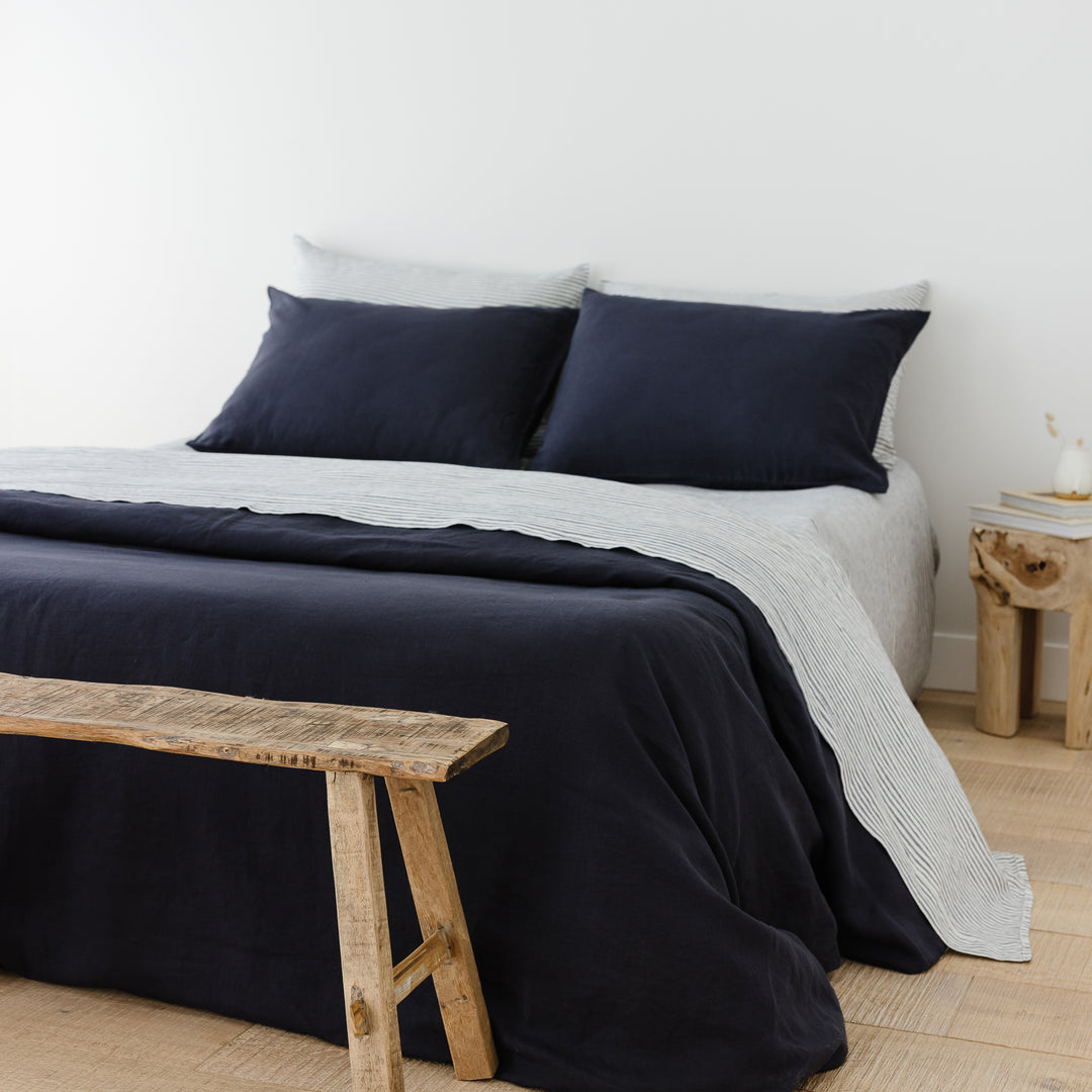 Foxtrot Home French Flax Linen styled in a bedroom with Midnight Blue Duvet.