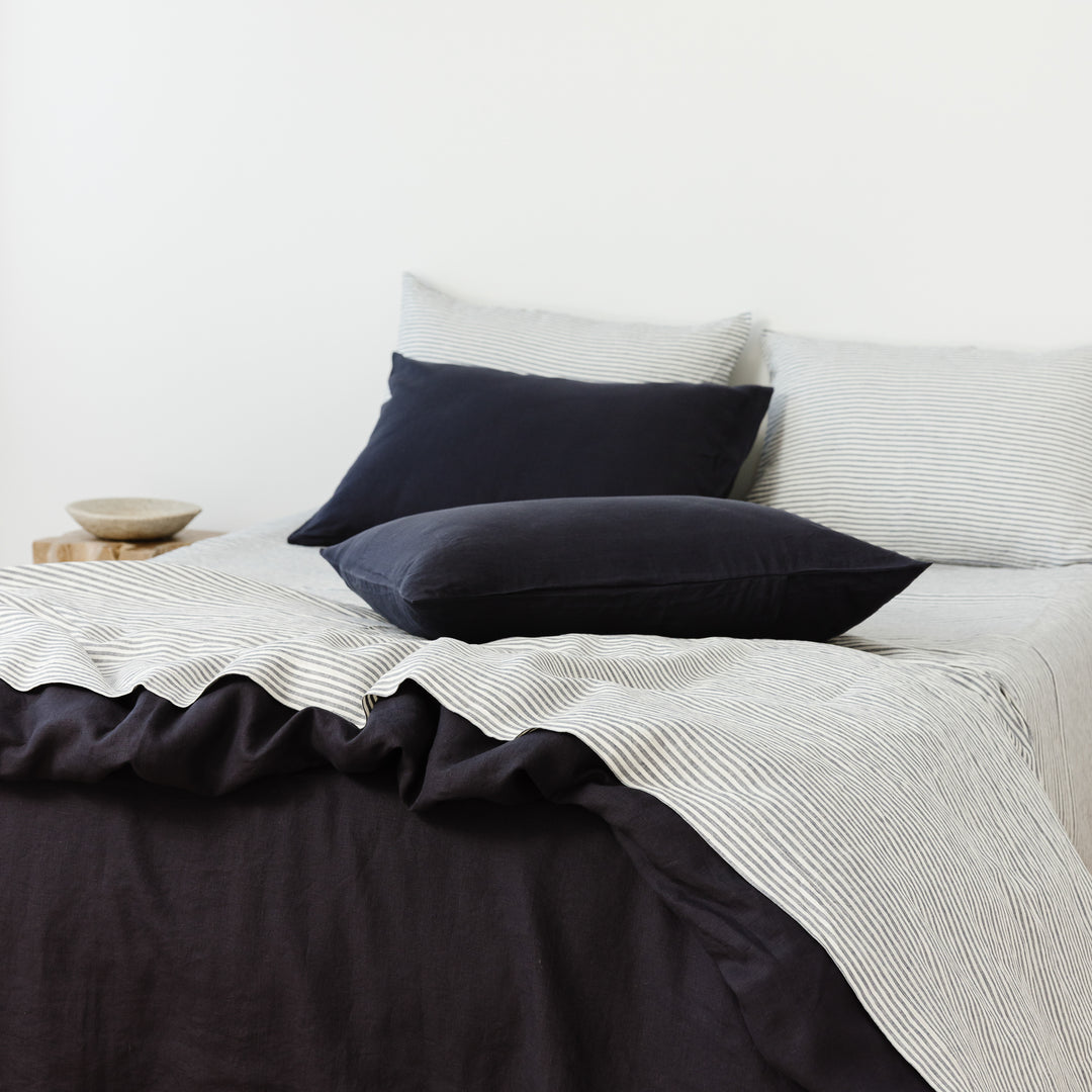 Foxtrot Home French Flax Linen styled in a bedroom with Midnight Blue Duvet.