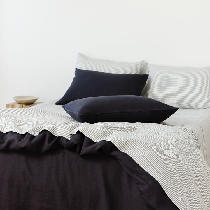 Foxtrot Home French Flax Linen styled in a bedroom with Midnight Blue Duvet.