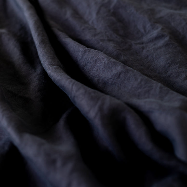 Foxtrot Home French Flax Linen styled in a bedroom with Midnight Blue Fitted Sheet.