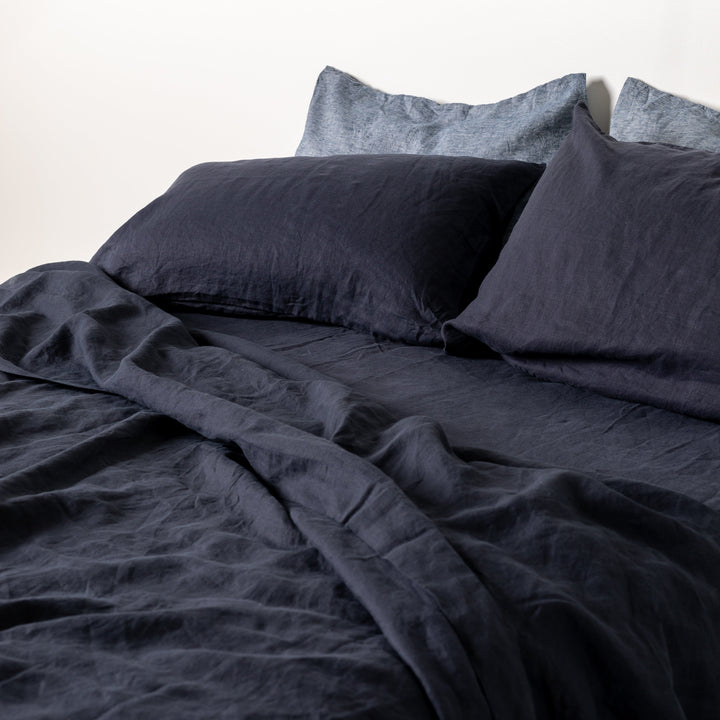 Foxtrot Home French Flax Linen styled in a bedroom with Midnight Blue Sheets Sets.