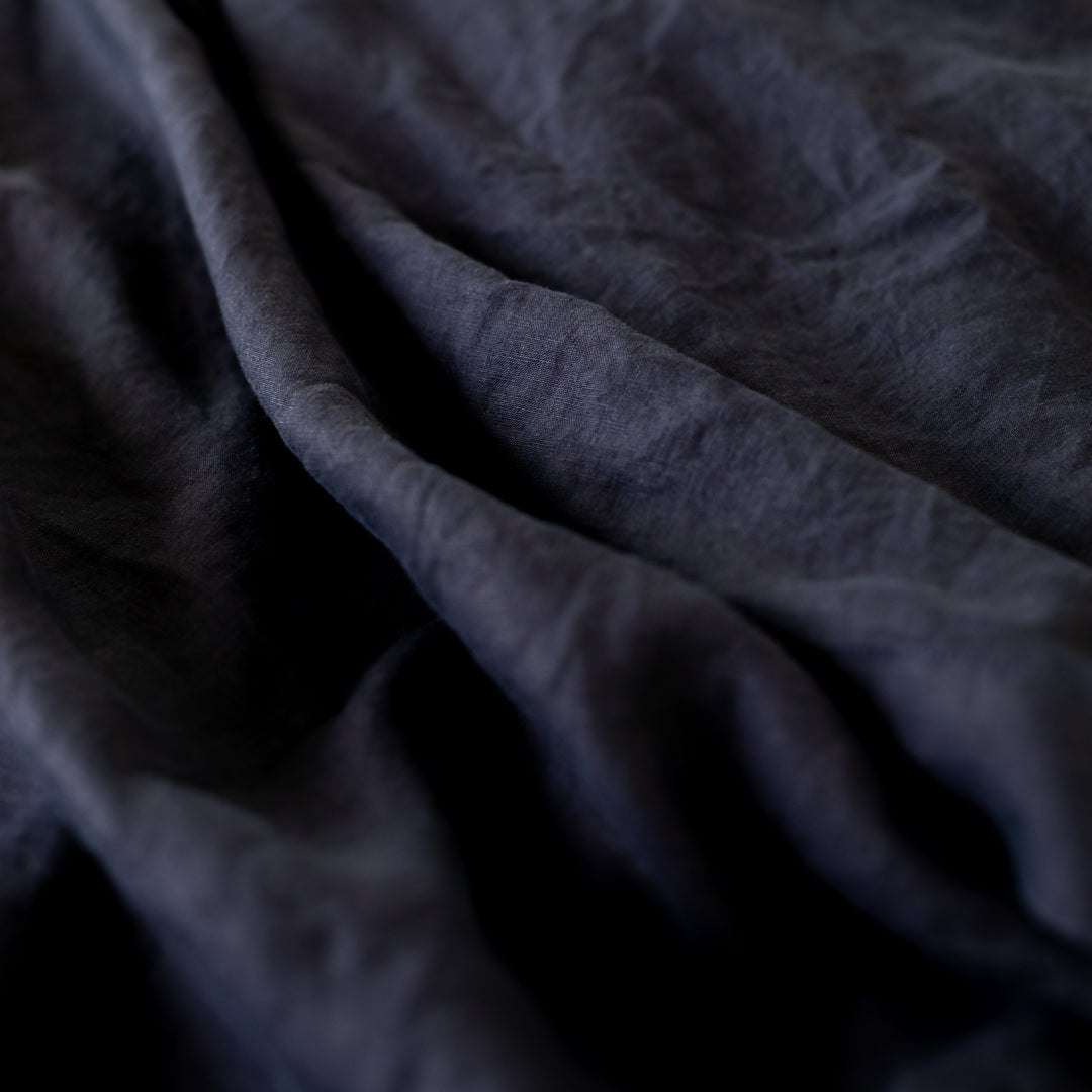 Foxtrot Home French Flax Linen styled in a bedroom with Midnight Blue Sheets Sets.