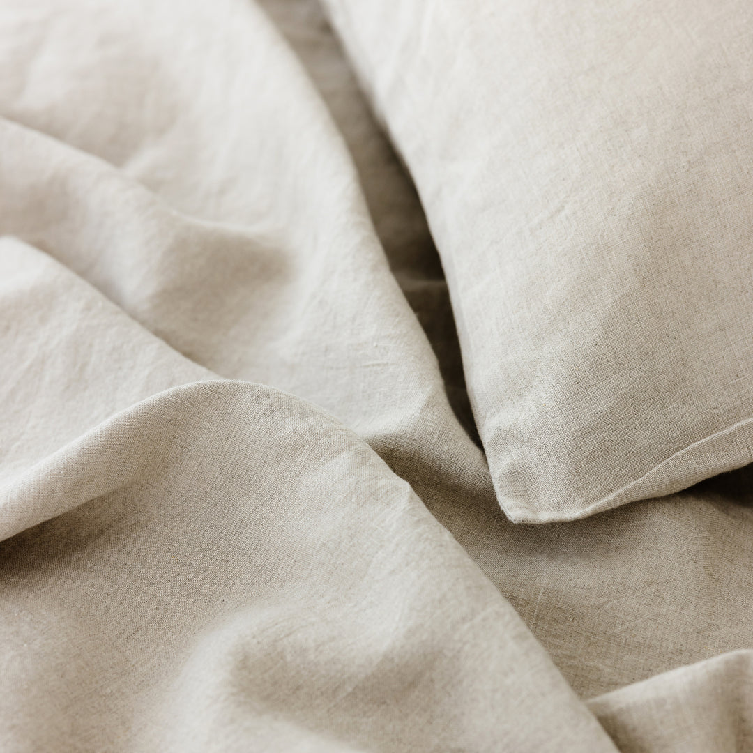 Foxtrot Home French Flax Linen styled in a bedroom with Natural Cushion Cover.