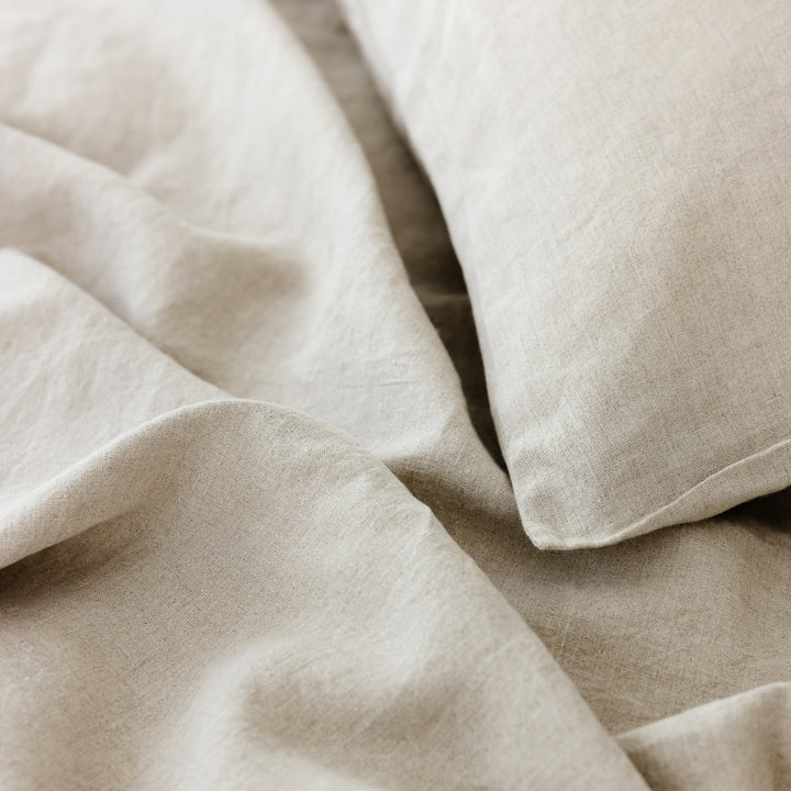 Foxtrot Home French Flax Linen styled in a bedroom with Natural Cushion Cover.