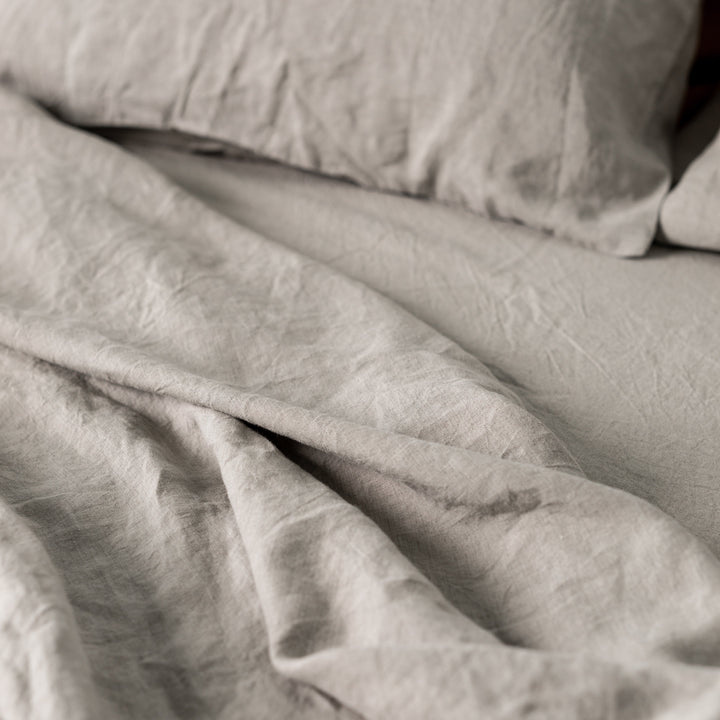 Foxtrot Home French Flax Linen styled in a bedroom with Natural Cushion Cover.