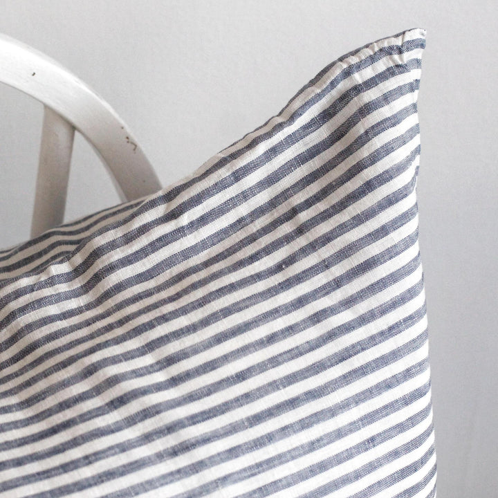 Foxtrot Home French Flax Linen styled in a bedroom with Navy Stripes Cushion Cover.