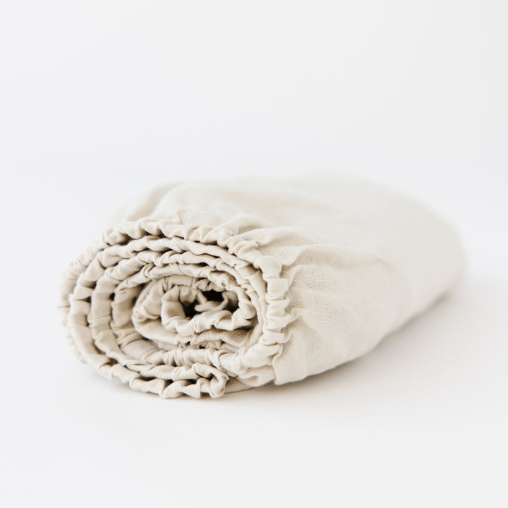 Foxtrot Home French Flax Linen styled in a baby's bedroom with Oat Cot Sheet and Bassinet Sheets.