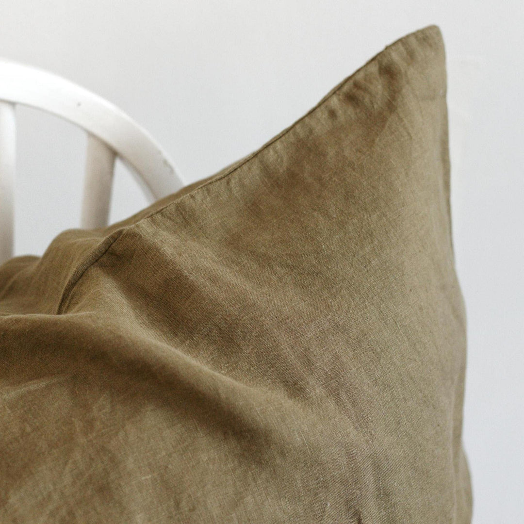 Foxtrot Home French Flax Linen styled in a bedroom with Olive Green Cushion Cover.