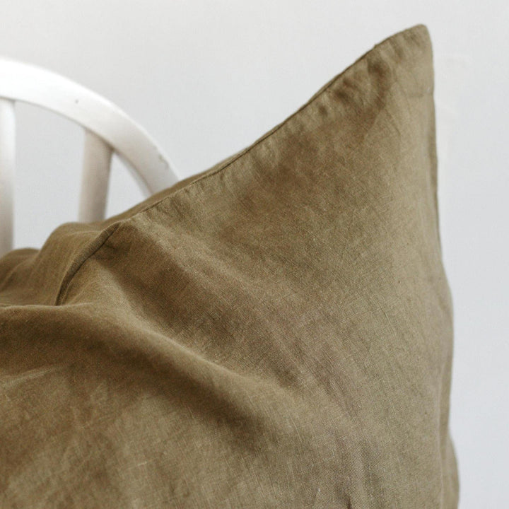 Foxtrot Home French Flax Linen styled in a bedroom with Olive Green Cushion Cover.