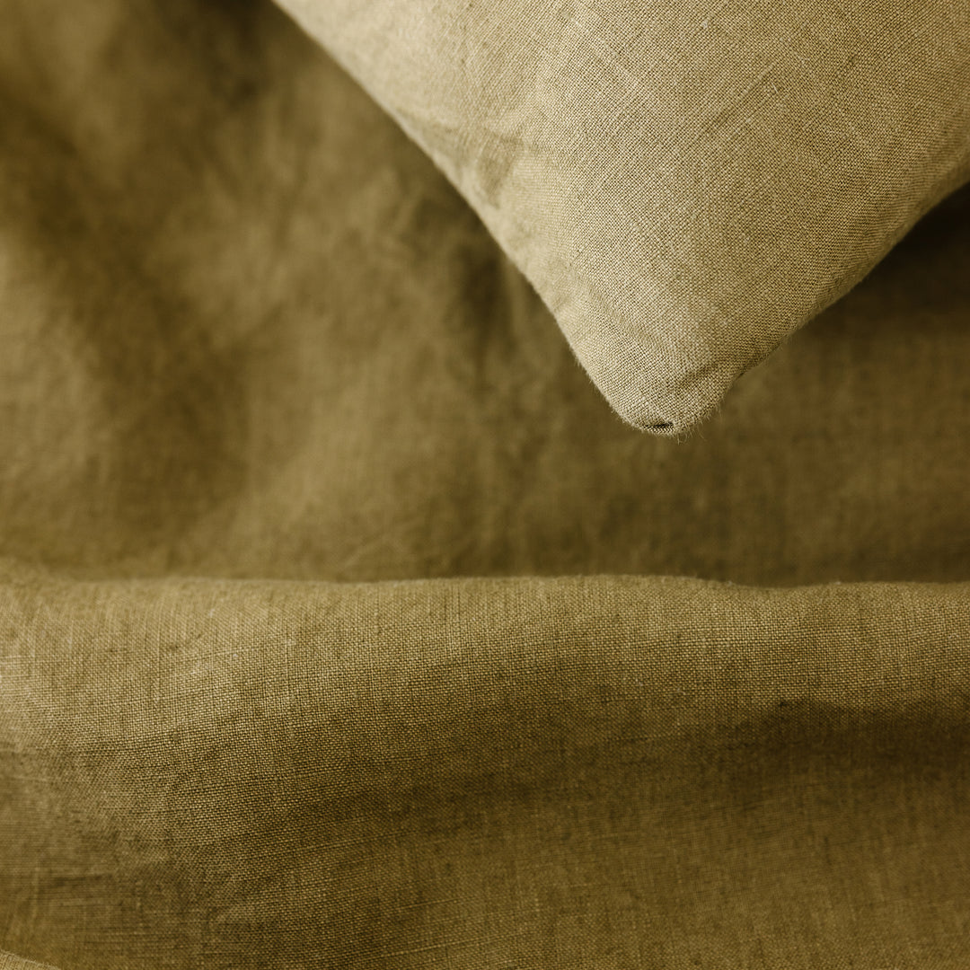Foxtrot Home French Flax Linen styled in a bedroom with Olive Green Sheets Sets.