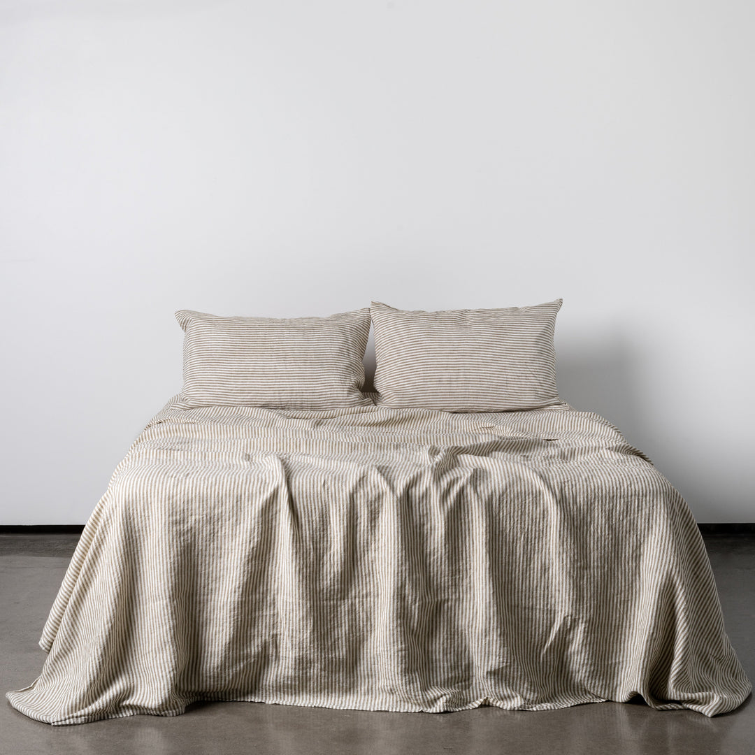Foxtrot Home French Flax Linen styled in a bedroom with Olive Green Stripes Sheets Sets.