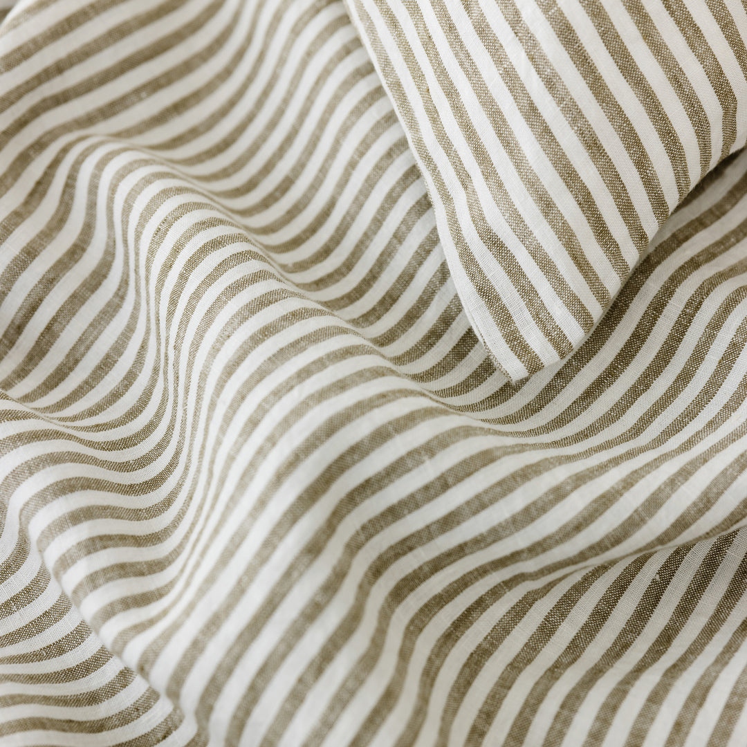 Foxtrot Home French Flax Linen styled in a bedroom with Olive Green Stripes Cushion Cover.