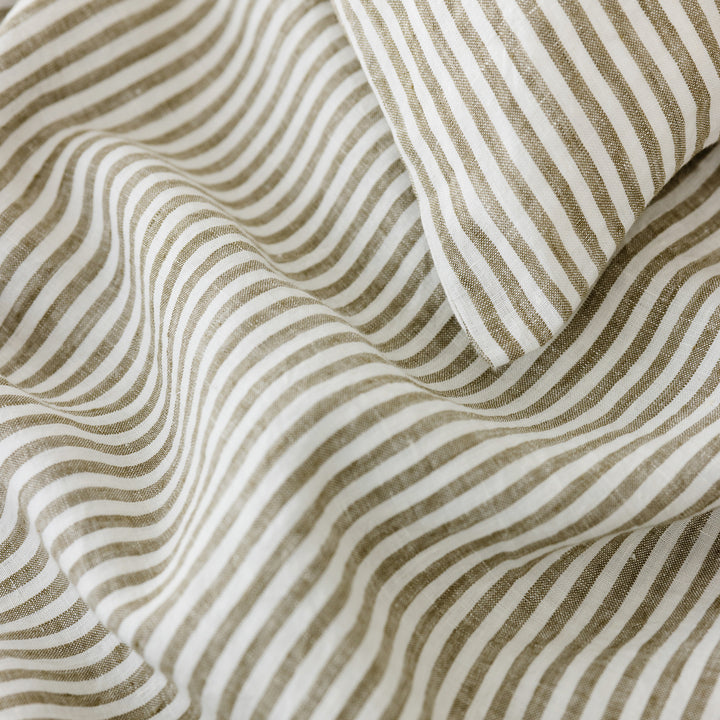 Foxtrot Home French Flax Linen styled in a bedroom with Olive Green Stripes Cushion Cover.