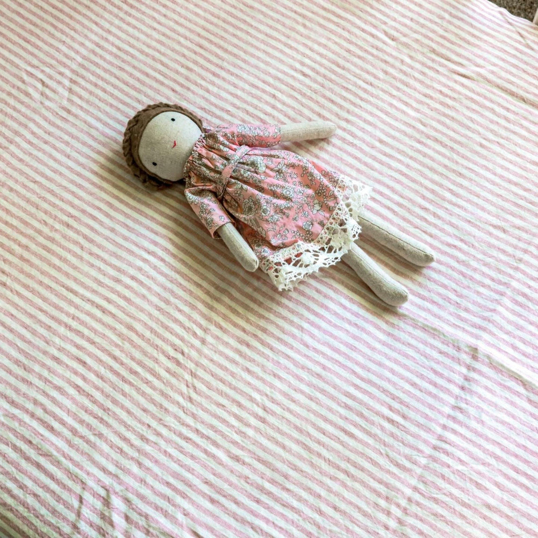 Foxtrot Home French Flax Linen styled in a baby's bedroom with Pink Stripes Cot Sheet and Bassinet Sheets.