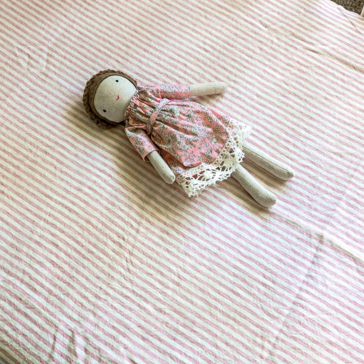 Foxtrot Home French Flax Linen styled in a baby's bedroom with Pink Stripes Cot Sheet and Bassinet Sheets.