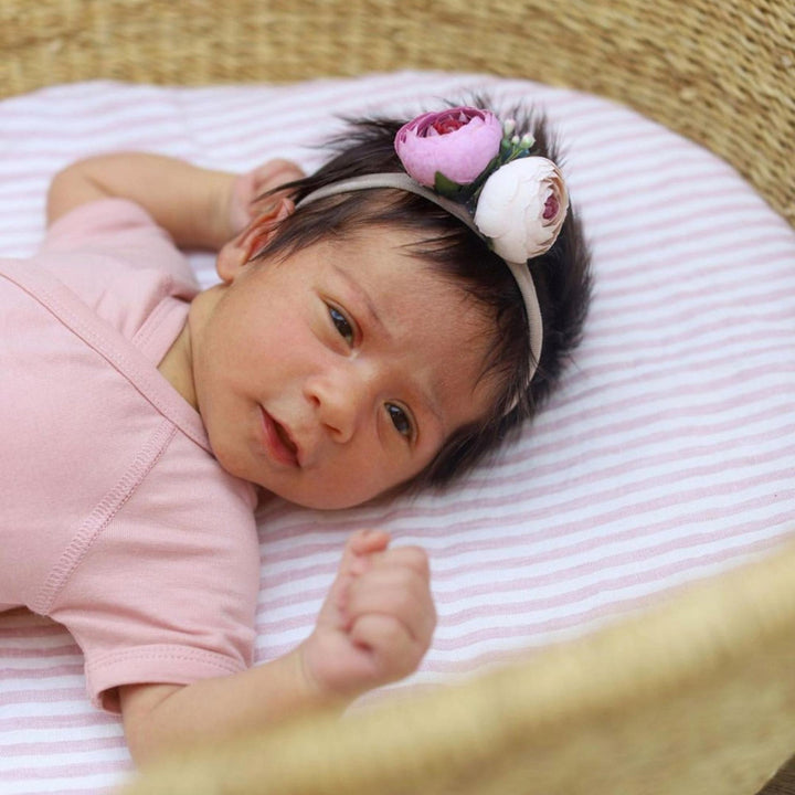 Foxtrot Home French Flax Linen styled in a baby's bedroom with Pink Stripes Cot Sheet and Bassinet Sheets.