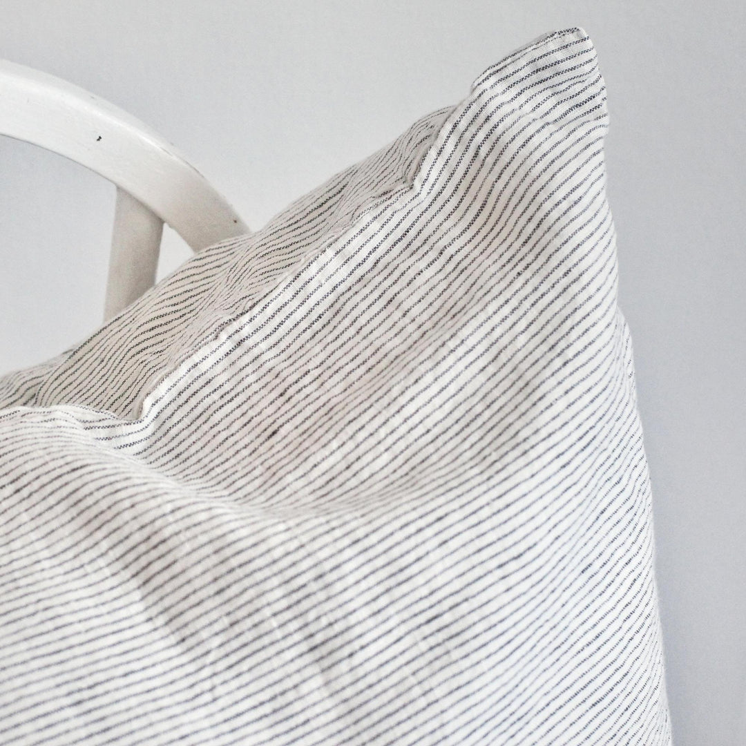 Foxtrot Home French Flax Linen styled in a bedroom with Pinstripes Cushion Cover.