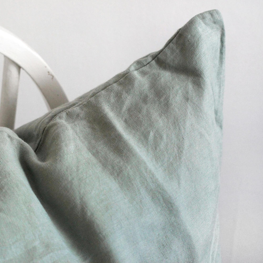 Foxtrot Home French Flax Linen styled in a bedroom with Sage Cushion Cover.