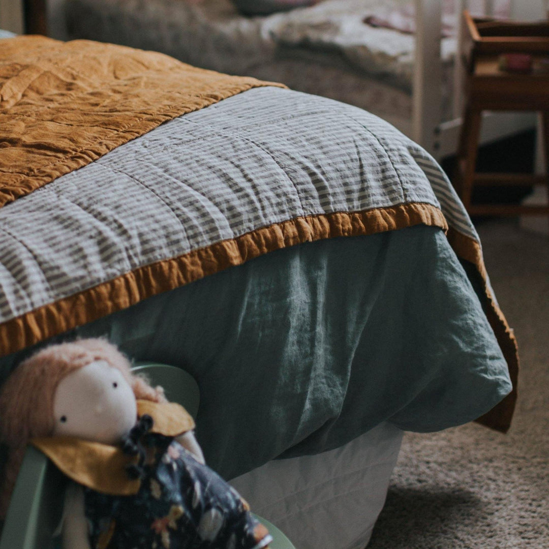 Foxtrot Home French Flax Linen styled in a bedroom with Sage Green Duvet, Grey Stripes Sheets and Pillowcases.