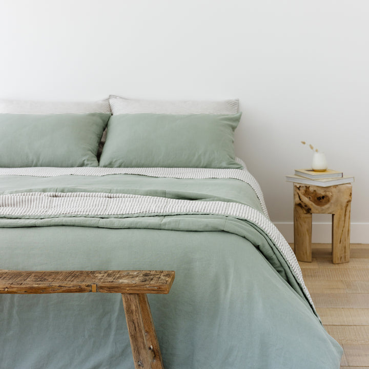 Foxtrot Home French Flax Linen styled in a bedroom with Sage Green Duvet, Grey Stripes Sheets and Pillowcases.