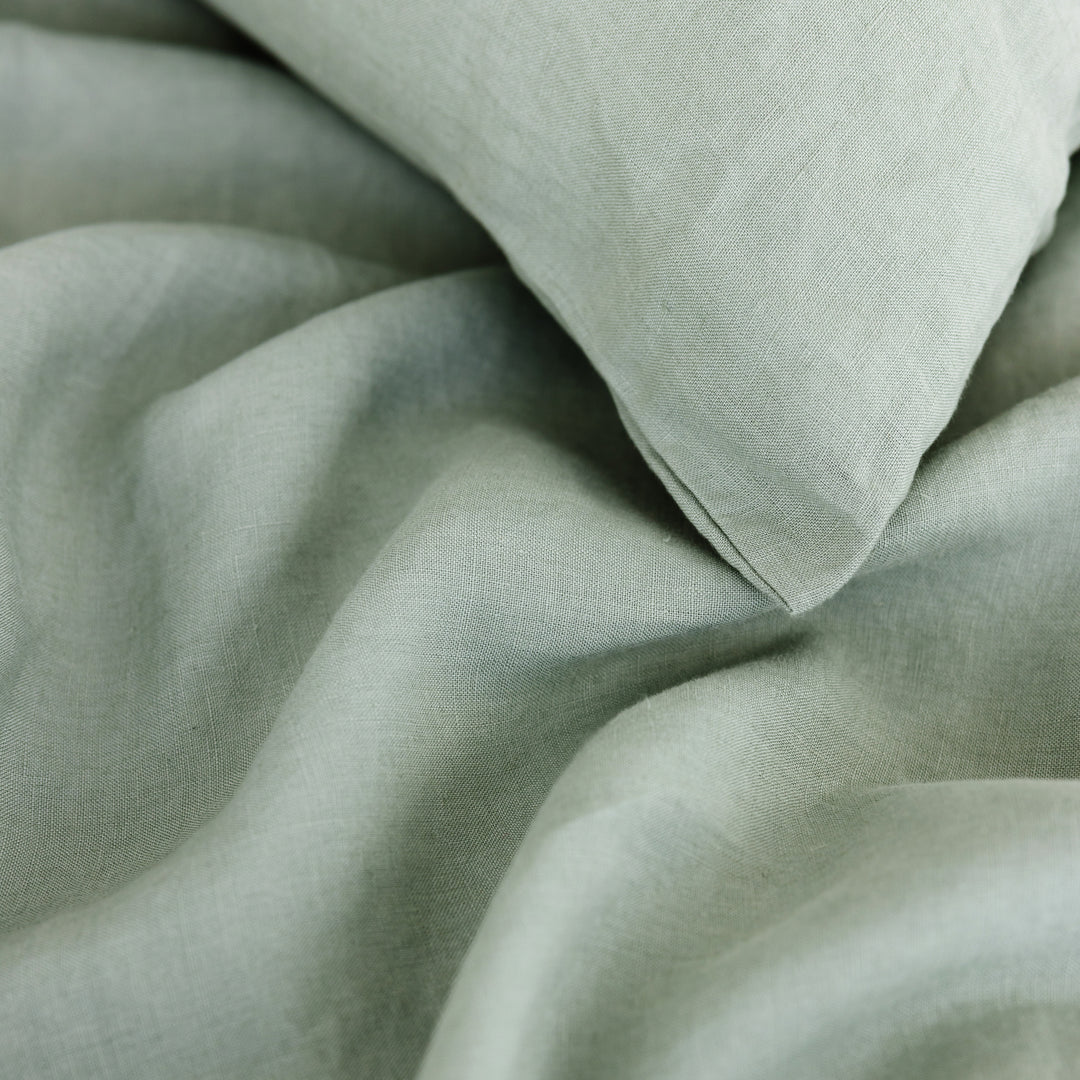 Foxtrot Home French Flax Linen styled in a bedroom with Sage Green Duvet, Grey Stripes Sheets and Pillowcases.