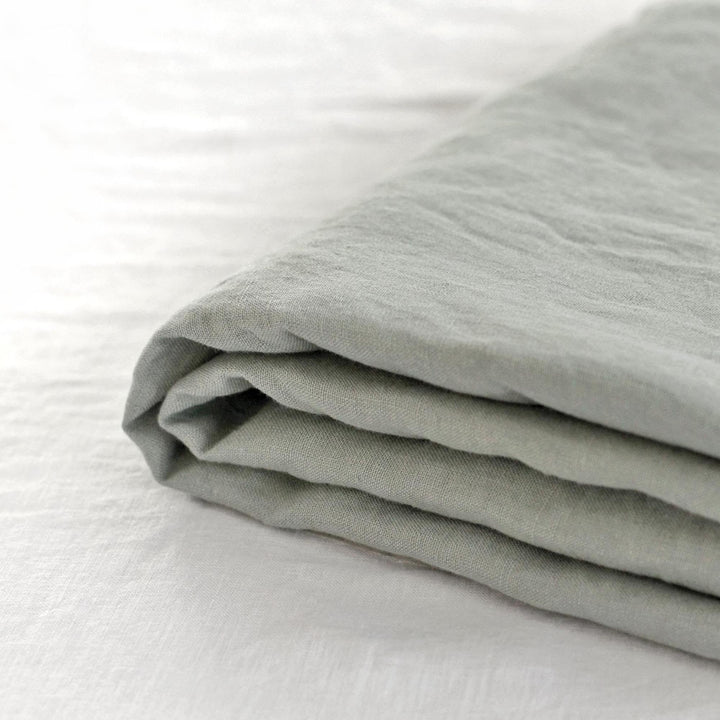 Foxtrot Home French Flax Linen styled in a bedroom with Sage Green Fitted Sheet.