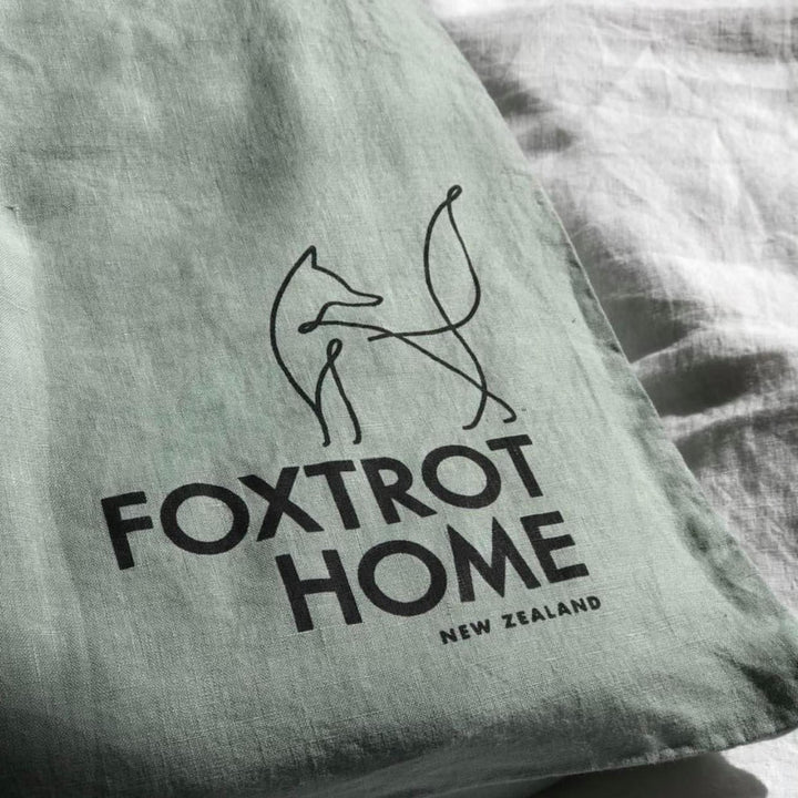 Foxtrot Home French Flax Linen styled in a bedroom with Sage Green Fitted Sheet.