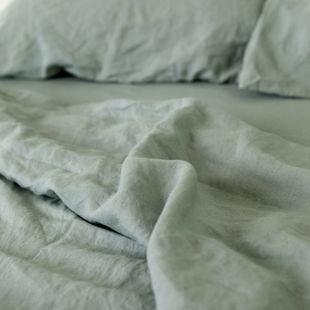 Foxtrot Home French Flax Linen styled in a bedroom with Sage Green Sheets Set.