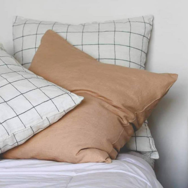 Foxtrot Home French Flax Linen styled in a bedroom with Tawny Peach Cushion Cover.