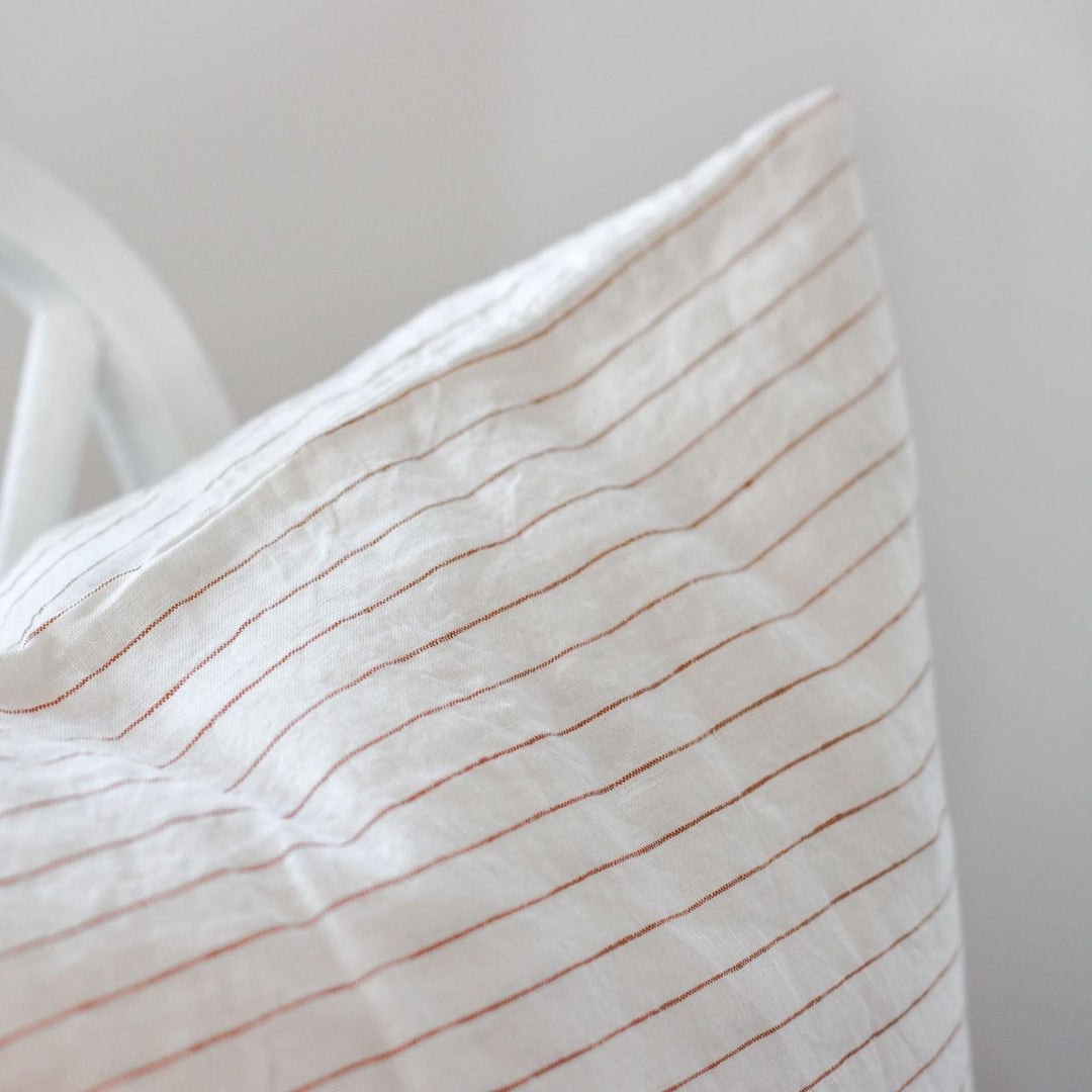 Foxtrot Home French Flax Linen styled in a bedroom with Tobacco Stripes Cushion Cover.