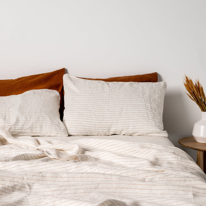 Foxtrot Home French Flax Linen styled in a bedroom with Tobacco Stripes Fitted Sheet.