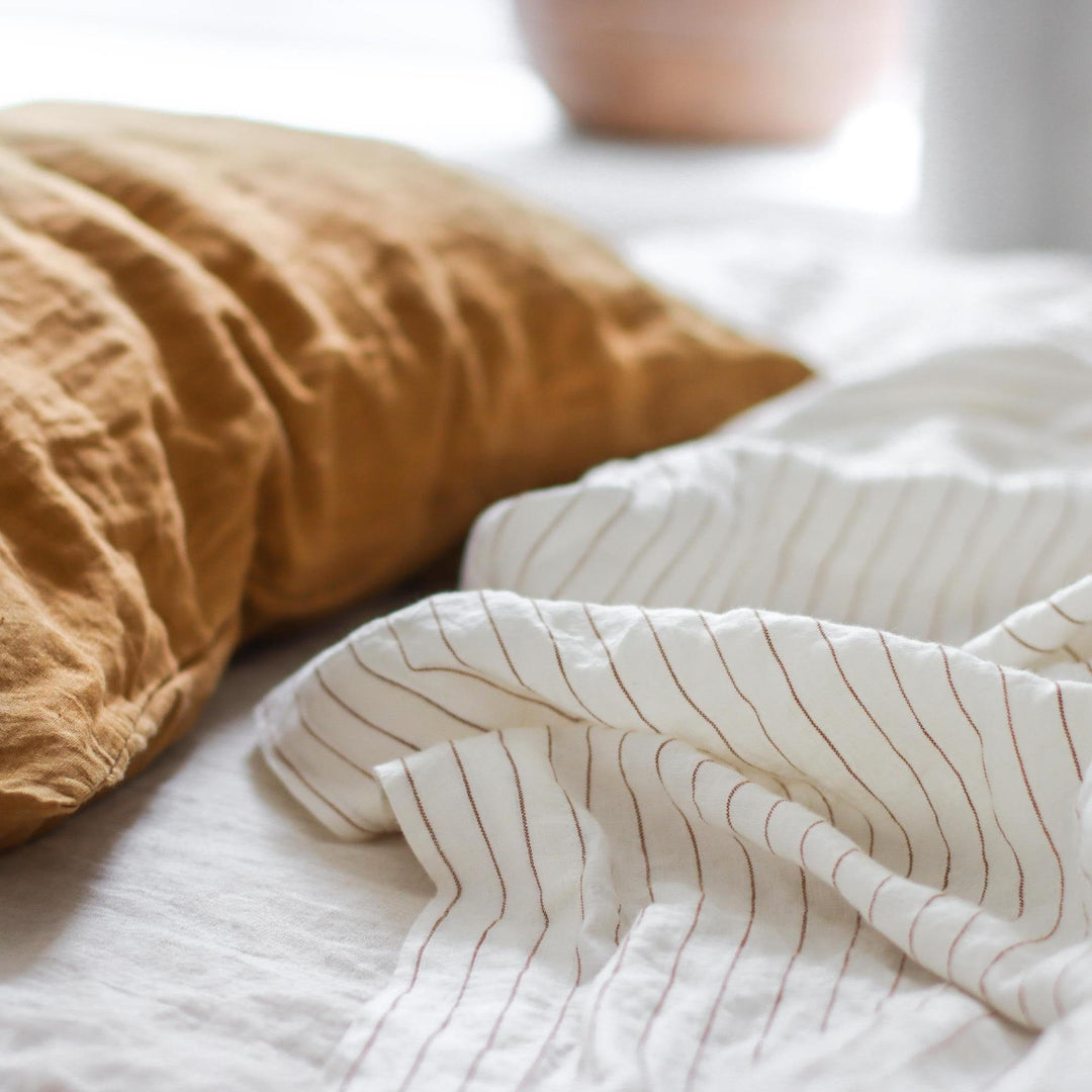Foxtrot Home French Flax Linen styled in a bedroom with Tobacco Stripes Fitted Sheet.