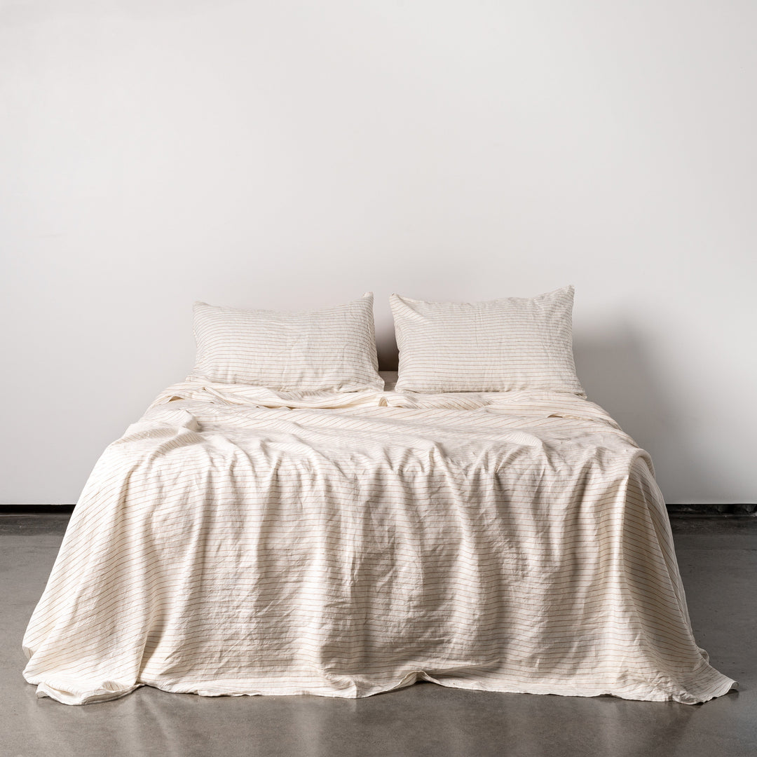 Foxtrot Home French Flax Linen styled in a bedroom with Tobacco Stripes Sheets Sets.