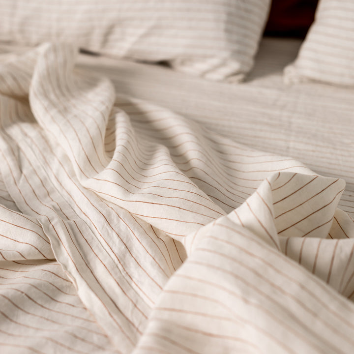 Foxtrot Home French Flax Linen styled in a bedroom with Tobacco Stripes Sheets Sets.