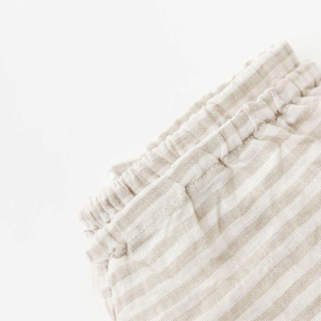 Foxtrot Home French Flax Linen styled in a baby's bedroom with Sand Stripes Cot Sheet and Bassinet Sheets.