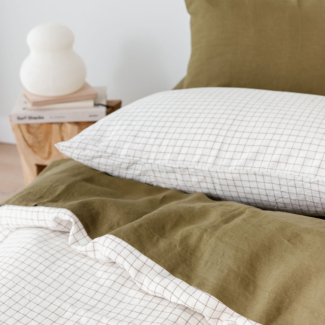 Foxtrot Home French Flax Linen styled with Malt Brown Grid PIllowcases and Olive Sheets
