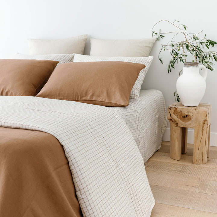 Foxtrot Home French Flax Linen styled with Malt Brown Grid Sheets and a Malt Brown Duvet