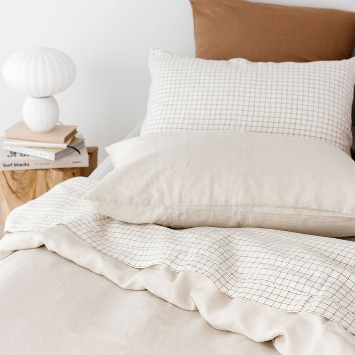 Foxtrot Home French Flax Linen styled in Malt Brown Grid with an Oat Duvet and PIllowcases