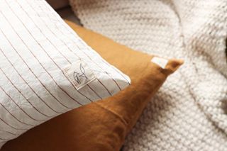 Foxtrot Home French Flax Linen styled in a bedroom with Tobacco Stripes Cushion Cover.