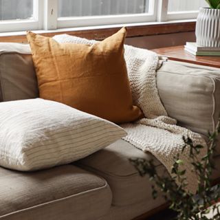 Foxtrot Home French Flax Linen styled in a bedroom with Ginger Honey Cushion Cover.