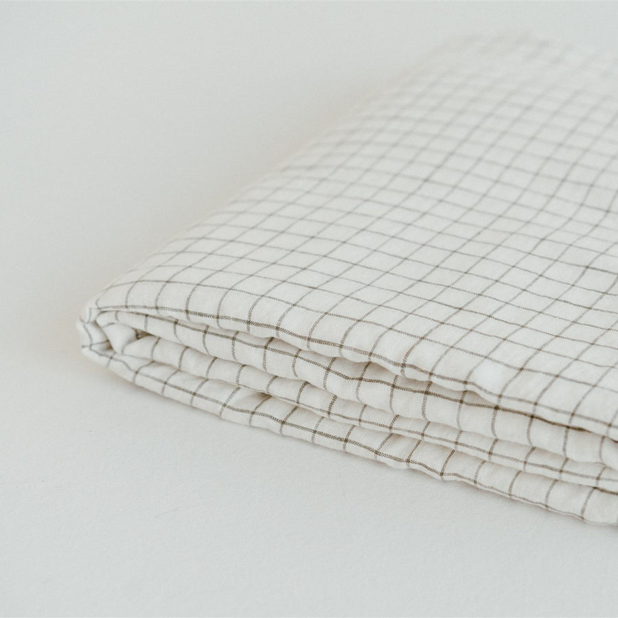 Foxtrot Home French Flax Linen styled in a bedroom with Cactus Grid Pillowcases