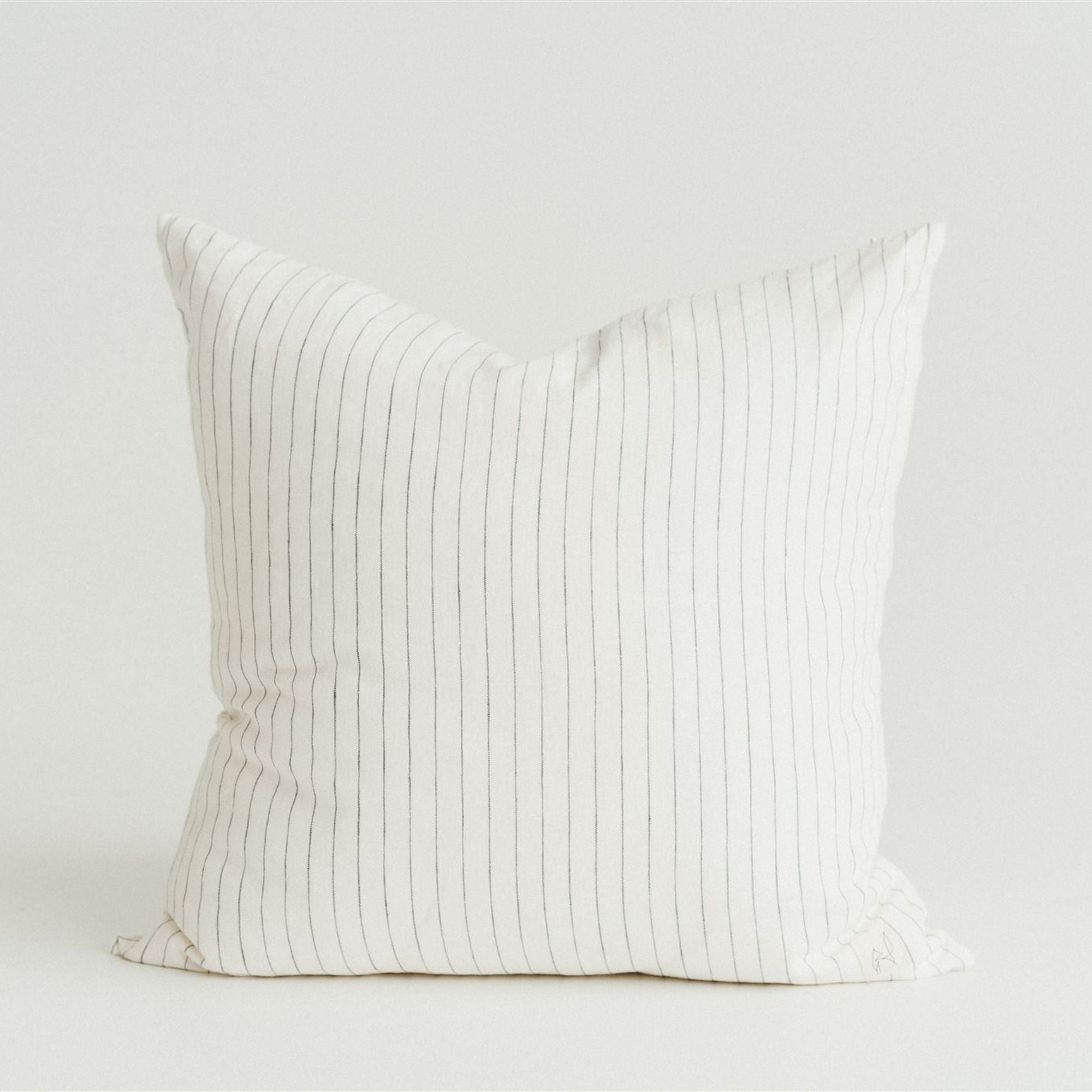 Foxtrot Home French Linen in a bedroom with Coastal Blue Stripes Cushion Cover.