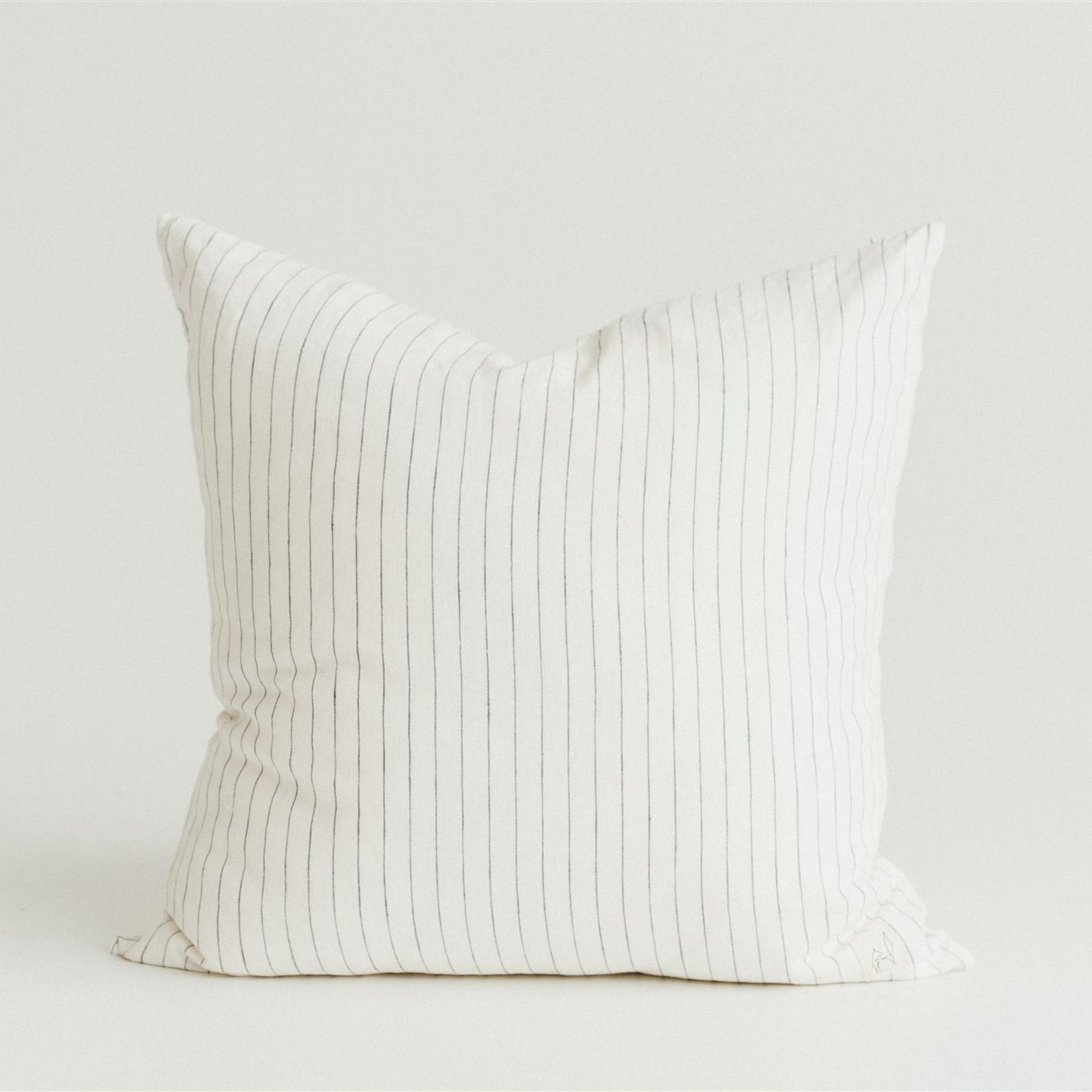Foxtrot Home French Linen in a bedroom with Coastal Blue Stripes Cushion Cover.