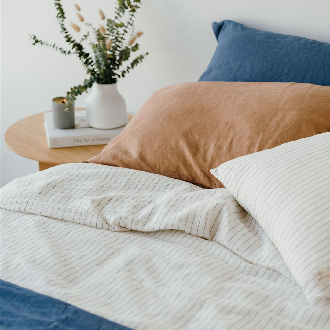 Foxtrot Home French Flax Linen styled in a bedroom with Coastal Blue Stripes Fitted Sheet