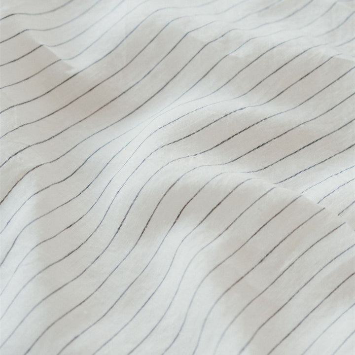 Foxtrot Home French Linen in a bedroom with Coastal Blue Stripes Cushion Cover.