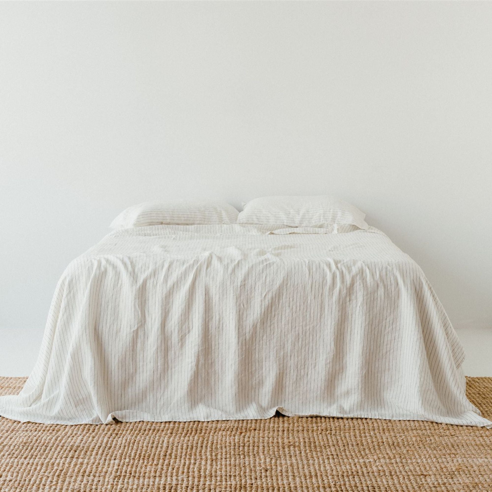 Foxtrot Home French Flax Linen styled in a bedroom with Coastal Blue Stripes Fitted Sheet